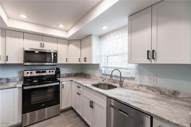 kitchen with white cabinetry, sink, and appliances with stainless steel finishes