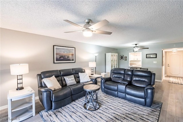 living room with light hardwood / wood-style flooring and a textured ceiling