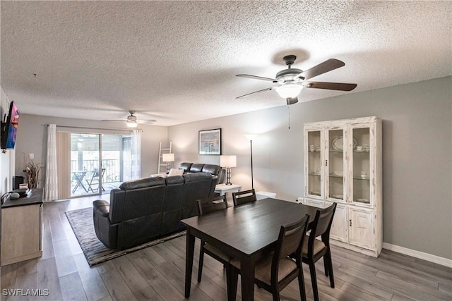 dining area with ceiling fan, light hardwood / wood-style flooring, and a textured ceiling