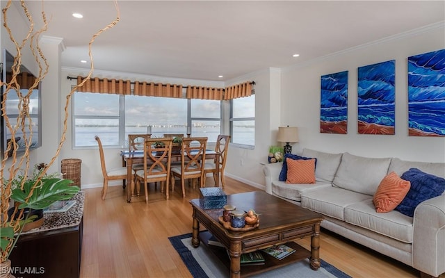 living room with hardwood / wood-style floors and ornamental molding