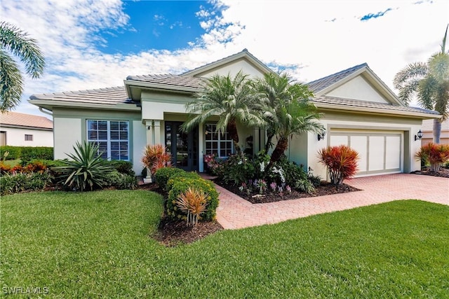 view of front of house with a front yard and a garage