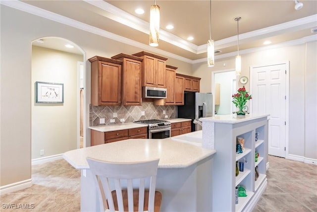 kitchen featuring pendant lighting, a center island, decorative backsplash, a kitchen bar, and stainless steel appliances