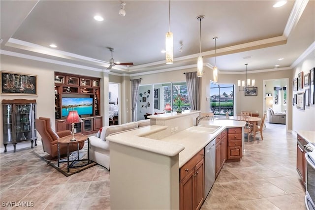 kitchen with a tray ceiling, sink, stainless steel appliances, and ceiling fan with notable chandelier