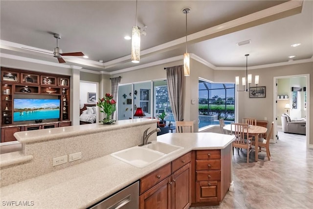 kitchen featuring ceiling fan with notable chandelier, sink, stainless steel dishwasher, ornamental molding, and decorative light fixtures