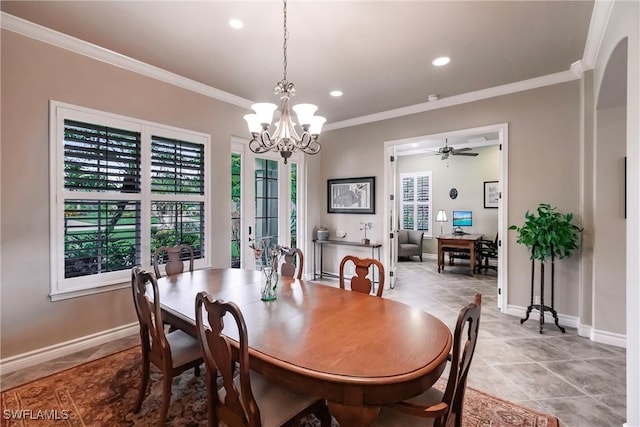 dining room with ceiling fan with notable chandelier and ornamental molding