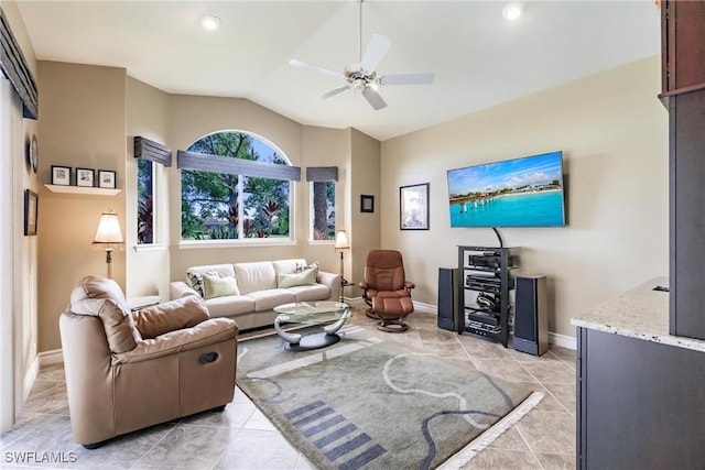 living room featuring lofted ceiling, light tile patterned floors, and ceiling fan