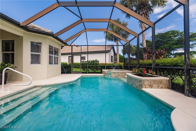 view of pool featuring a patio area, a lanai, and an in ground hot tub