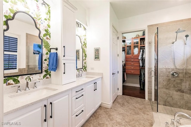 bathroom with tile patterned flooring, vanity, and walk in shower