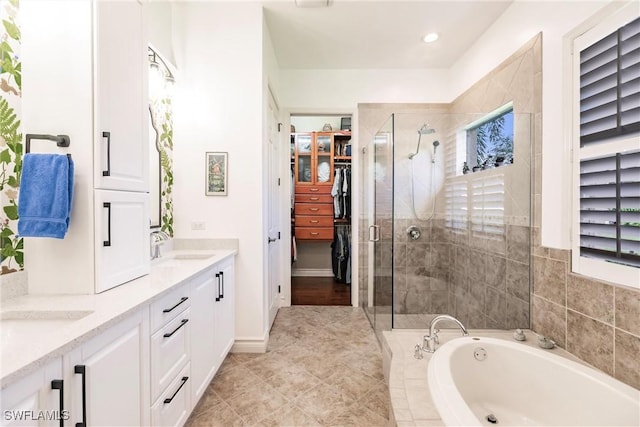 bathroom with plus walk in shower, tile patterned flooring, and vanity