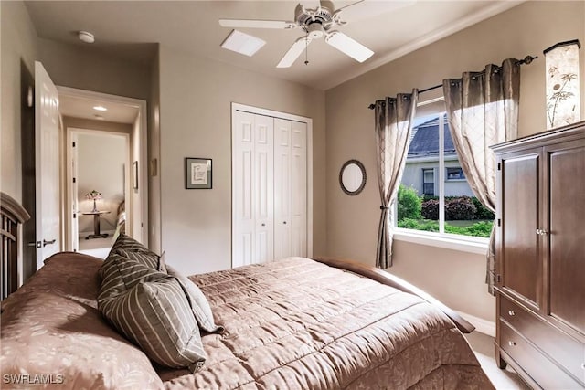 bedroom with ceiling fan and a closet