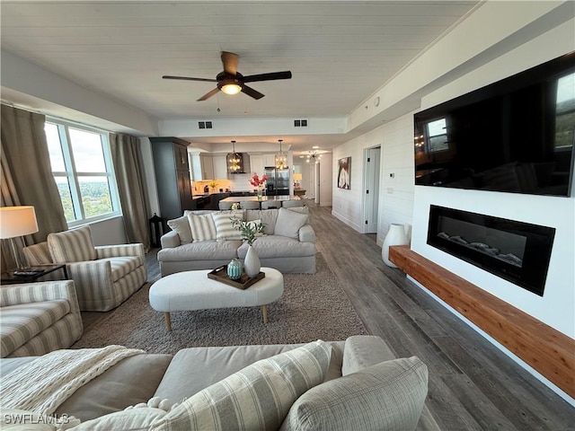 living room with dark hardwood / wood-style floors and ceiling fan