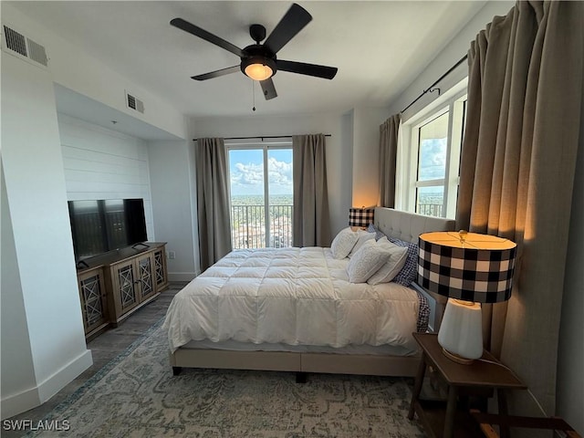 bedroom with dark hardwood / wood-style floors, access to outside, and ceiling fan