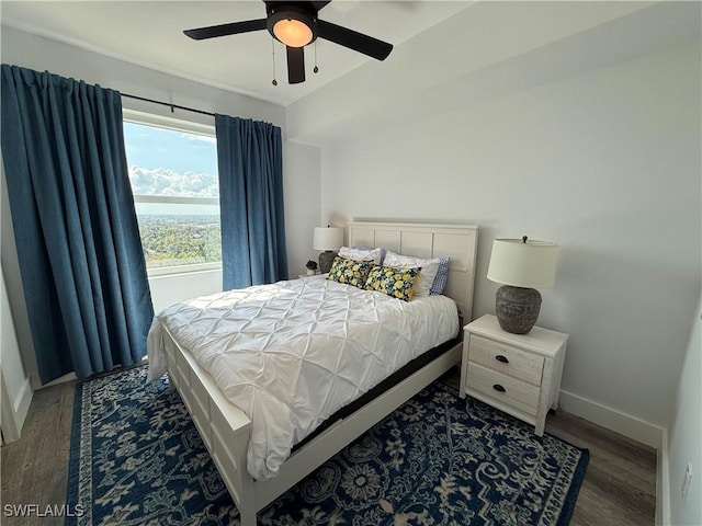 bedroom with ceiling fan and dark hardwood / wood-style flooring