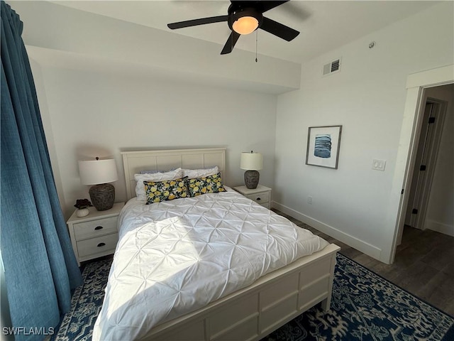 bedroom with dark hardwood / wood-style floors and ceiling fan