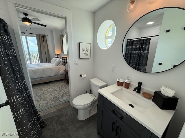 bathroom with ceiling fan, vanity, toilet, and a shower with shower curtain