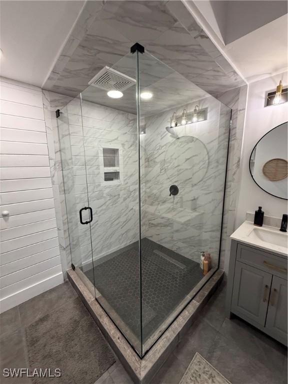 bathroom featuring walk in shower and vanity