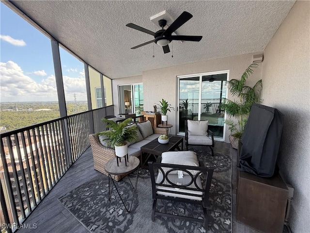 sunroom featuring ceiling fan