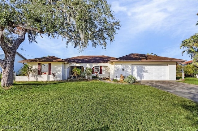 ranch-style home featuring a garage and a front lawn