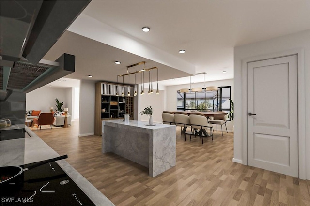 kitchen with a center island, decorative light fixtures, light hardwood / wood-style floors, and sink