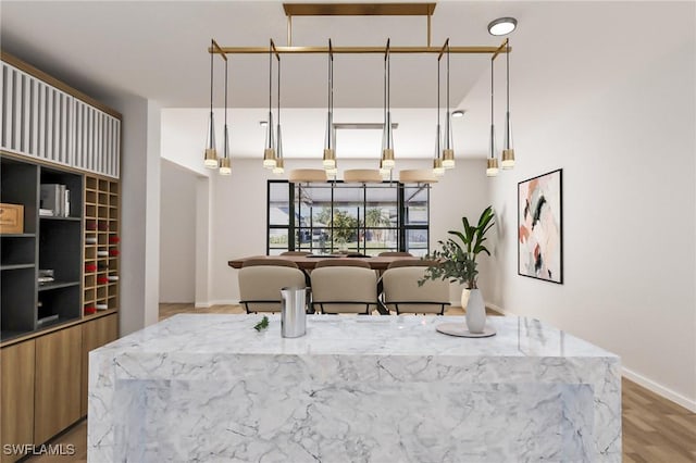 kitchen with pendant lighting and light wood-type flooring