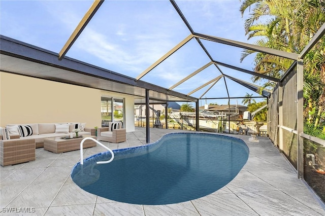 view of pool with a patio area, glass enclosure, and an outdoor hangout area