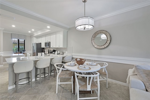 dining room with light tile patterned floors and ornamental molding