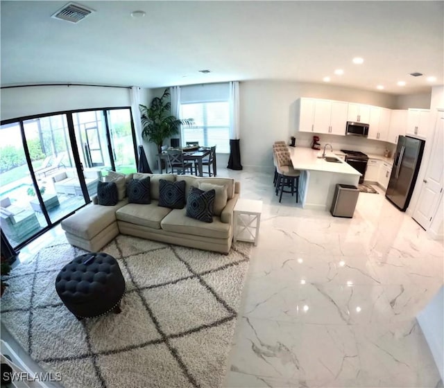 12830 Hawkins Dr, Estero, FL 33928 - living area featuring light marble finish floors and recessed lighting