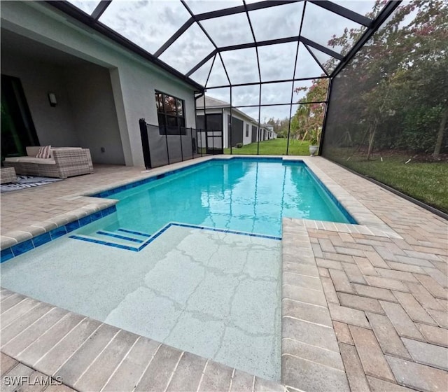 view of swimming pool featuring a lanai and a patio area