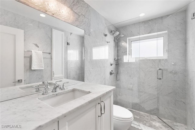 bathroom with vanity, a shower with shower door, and toilet