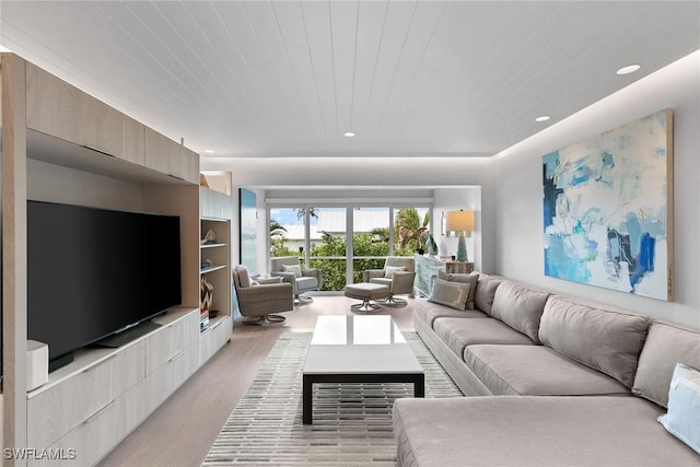 living room featuring light hardwood / wood-style floors and wooden ceiling