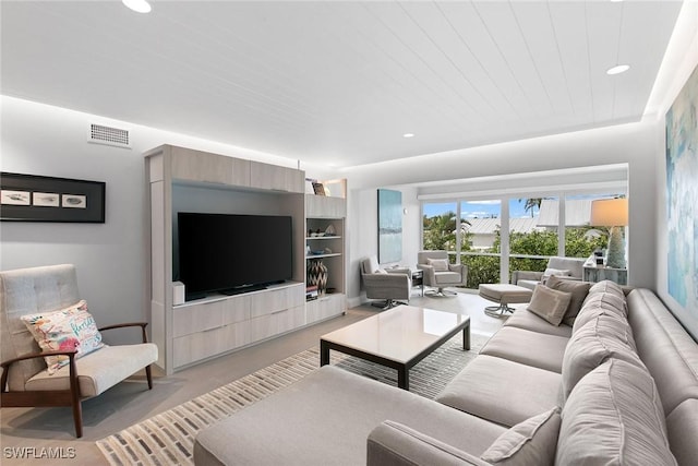 living room with built in shelves and wood ceiling