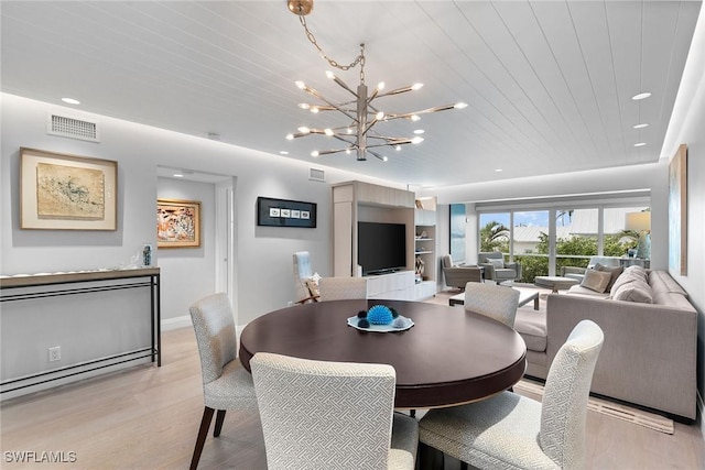 dining space featuring light hardwood / wood-style floors, wooden ceiling, and a notable chandelier