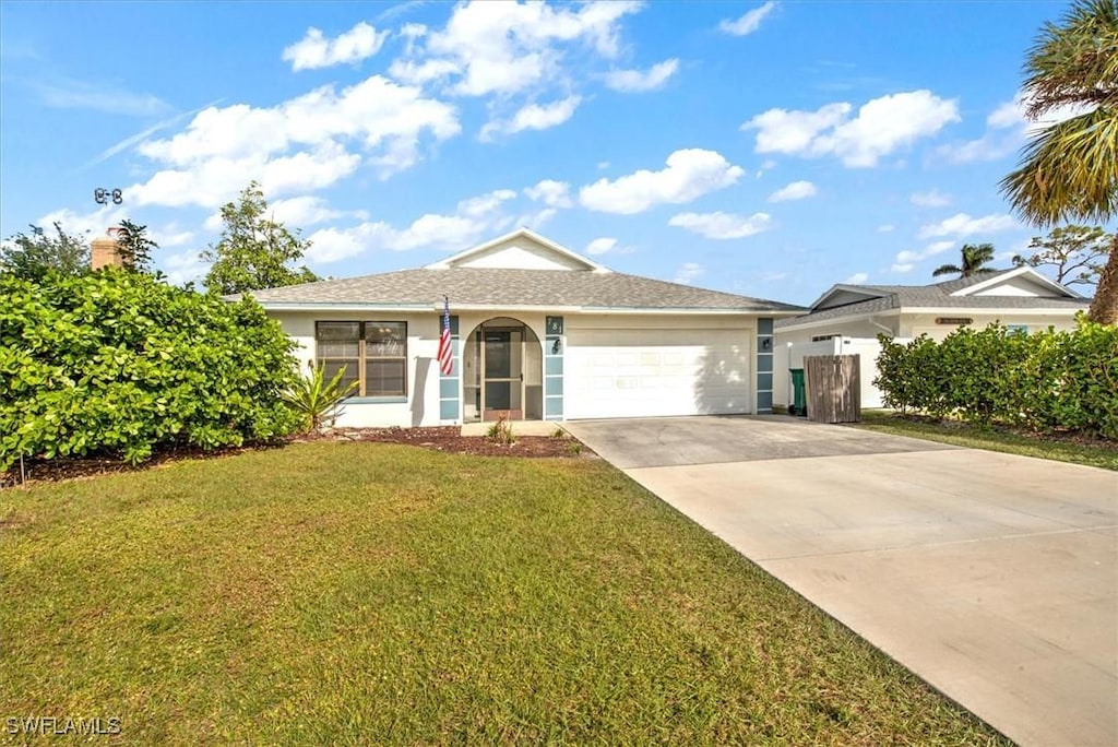 single story home featuring a front yard and a garage