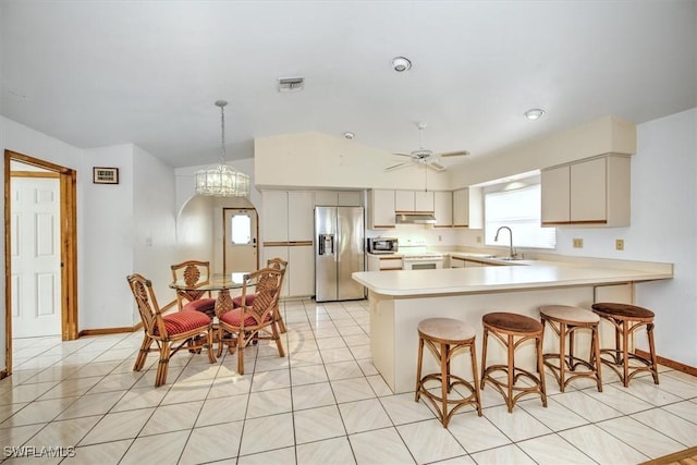 kitchen with pendant lighting, sink, stainless steel refrigerator with ice dispenser, electric range, and ceiling fan