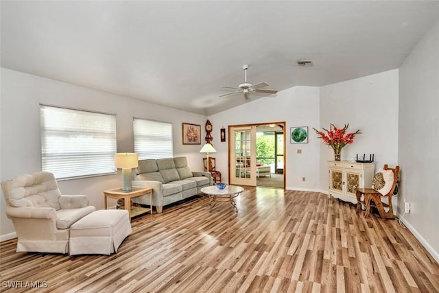 living room with ceiling fan, light wood-type flooring, and lofted ceiling