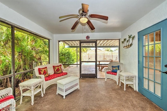 sunroom featuring ceiling fan