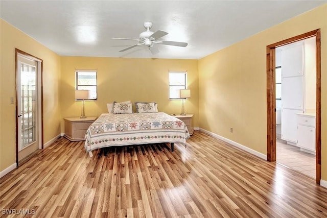 bedroom featuring ensuite bath, light hardwood / wood-style flooring, and ceiling fan