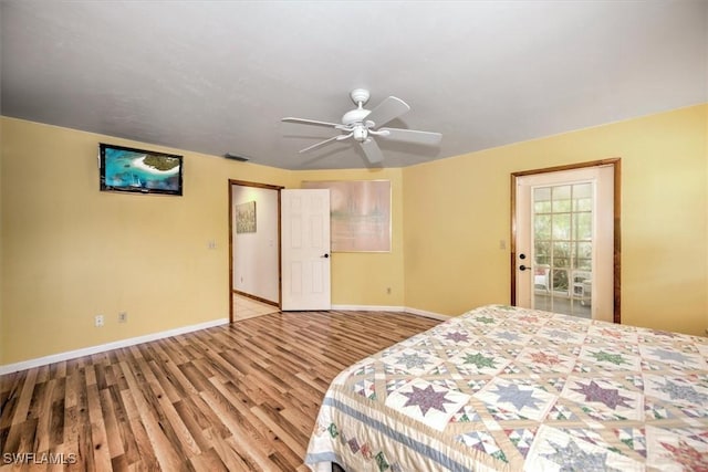 bedroom featuring access to exterior, ceiling fan, and light hardwood / wood-style flooring