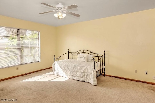 bedroom featuring ceiling fan and light carpet