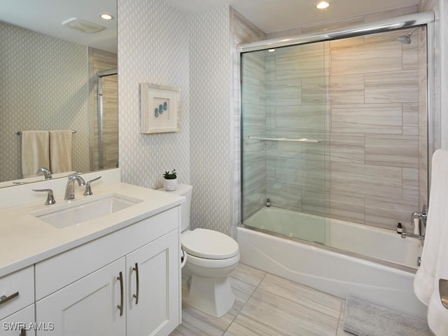 full bathroom with tile patterned flooring, vanity, bath / shower combo with glass door, and toilet