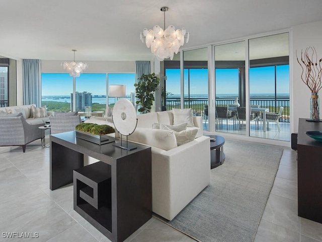 living room with expansive windows, plenty of natural light, a water view, and a notable chandelier