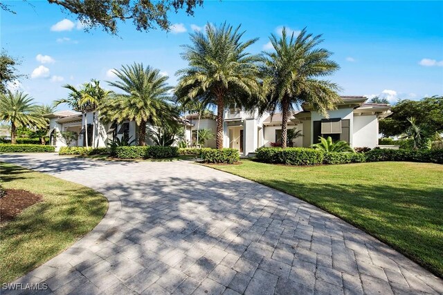 mediterranean / spanish-style house featuring a front lawn