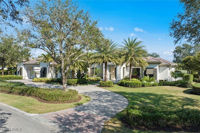 mediterranean / spanish house featuring a front yard