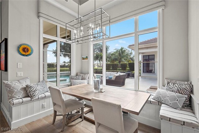 interior space featuring a water view and a notable chandelier