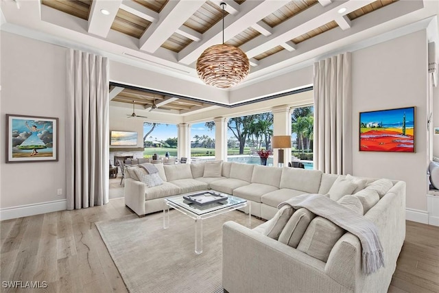 living room with ceiling fan, beam ceiling, and light wood-type flooring