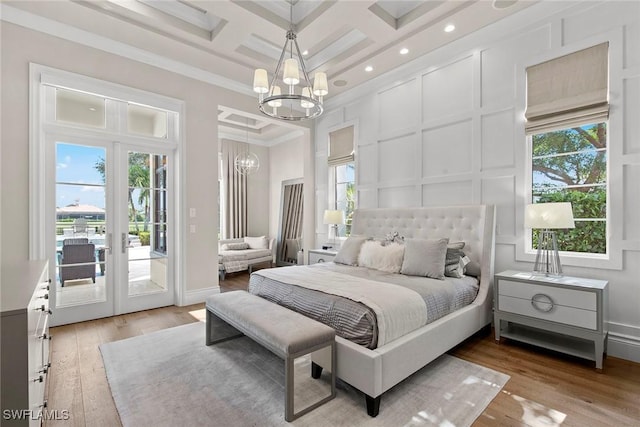 bedroom featuring access to exterior, ornamental molding, coffered ceiling, beamed ceiling, and a chandelier