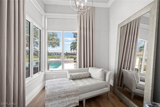 living area with a chandelier, hardwood / wood-style floors, and plenty of natural light