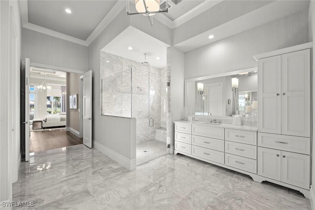 bathroom with vanity, a high ceiling, ceiling fan with notable chandelier, crown molding, and a shower with shower door