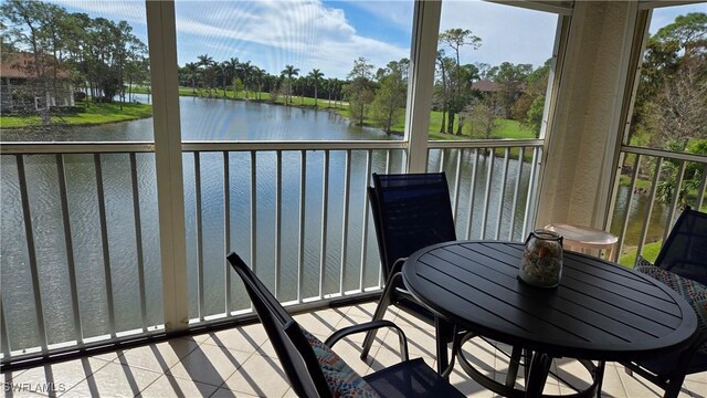 sunroom / solarium with a water view