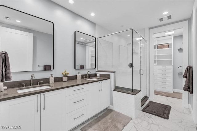 bathroom featuring vanity and a shower with shower door